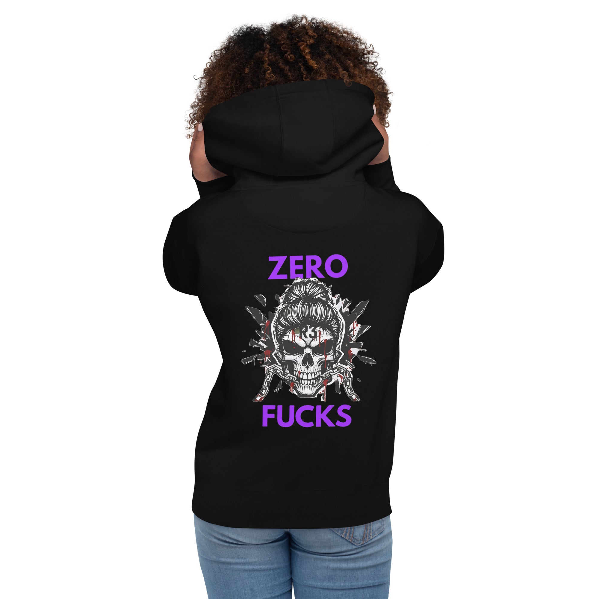 Woman wearing a black hoodie with a messy bun skull graphic design and purple text on the back.