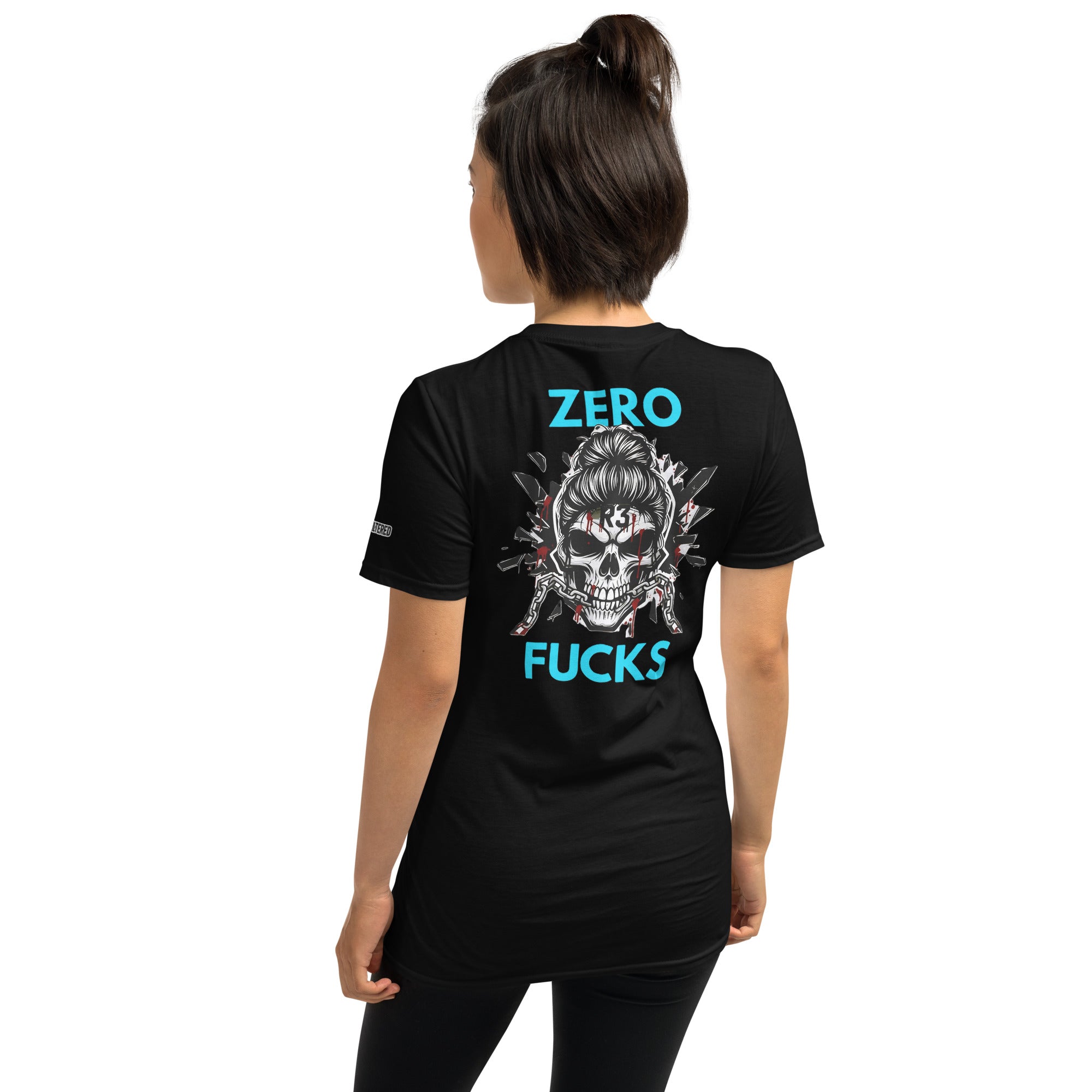 Woman wearing a black t-shirt with a skull design and teal text on the back