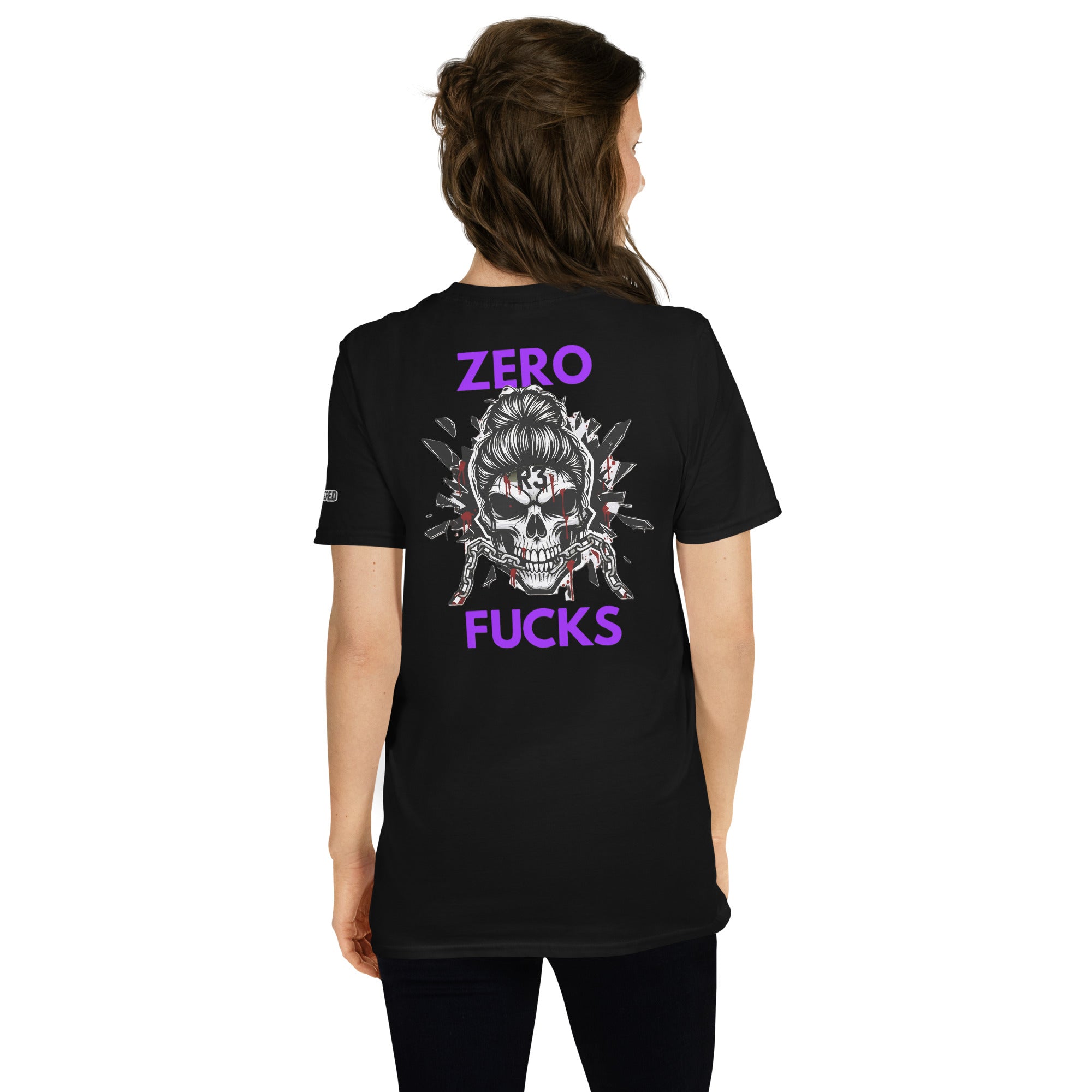 Woman wearing a black t-shirt with a skull design and purple text on the back