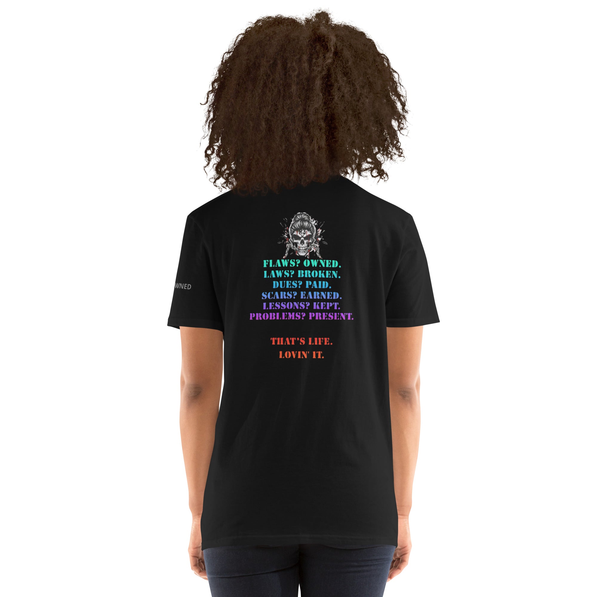 Woman wearing a black t-shirt with colorful text and graphics on the back.