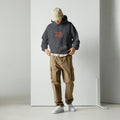 HEALING IS THE REBUILD Dark heather hoodie: industrial text graphic in silver. R3:UNFILTERED collection statement piece.
