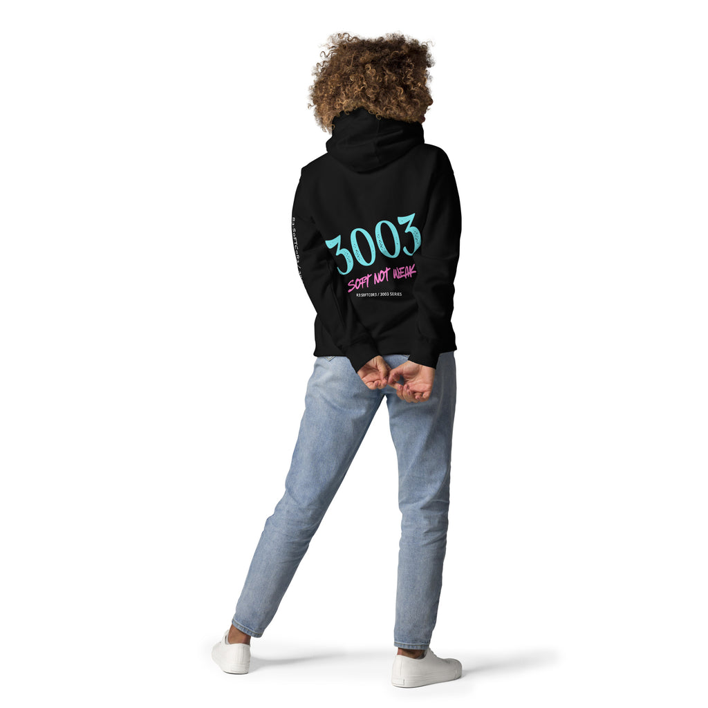 Woman wearing a black hoodie with  3003  - SOFT NOT WEAK  on the back.