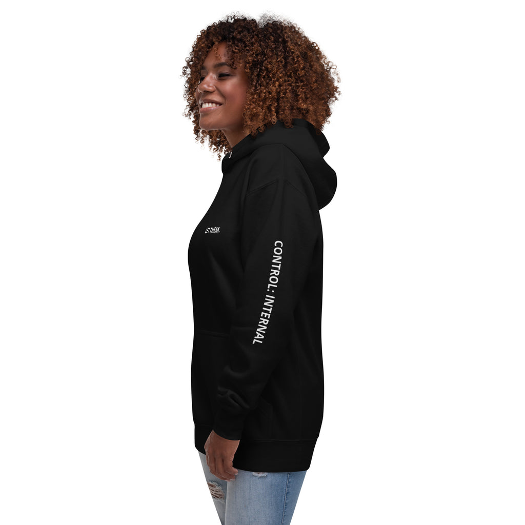 Woman wearing a black hoodie with Control: Internal text on left sleeve.