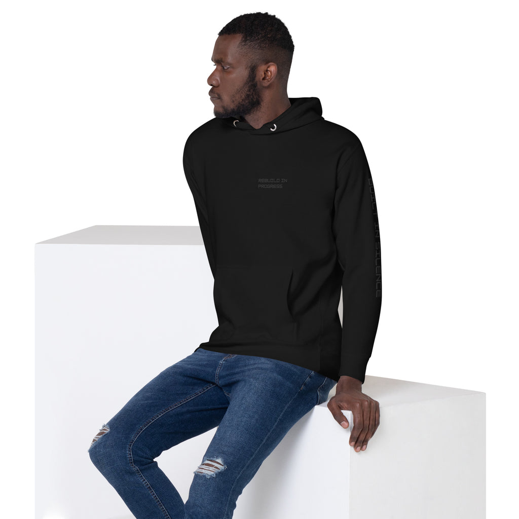 Man wearing a black hoodie with text BUILT IN SILENCE on left arm