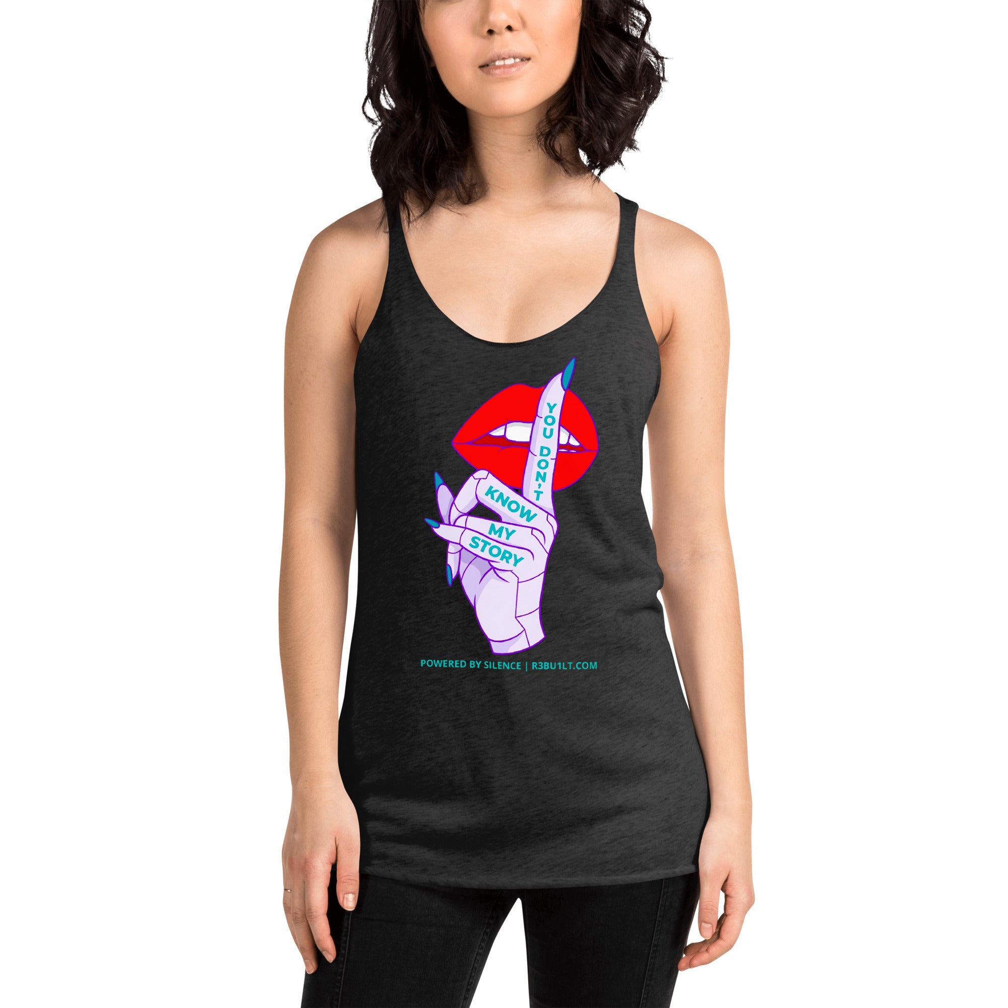 A woman modeling a dark heather gray racerback tank top with a colorful graphic on the front. The graphic features red lips, a purple hand, and blue text reading 'KNOW MY STORY'.